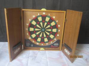 lot 39 image: GLD DART BOARD IN WOOD CABINET