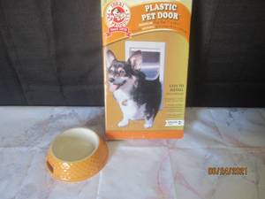 lot 120 image: PLASTIC PET DOOR WITH DOG BOWL