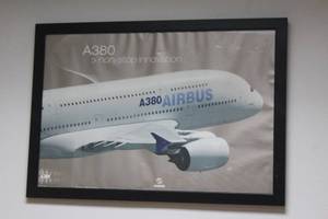 lot 146 image: A380 AIR BUS NON STOP INNOVATION PICTURE POSTER IN BLACK WOOD FRAME , 39X27