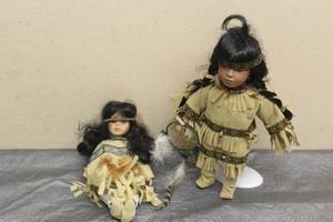 lot 179 image: TOTAL OF 2 VINTAGE AMERICAN INDIAN GIRLS PORCELAIN DOLLS , ONE WITH STAND  SEE PICS&nbsp