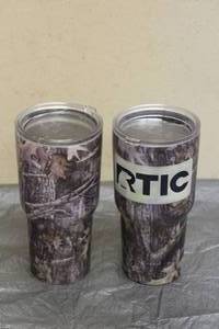 lot 37 image: TOTAL OF 2 - RTIC STAINLESS STEEL CAMO PRINT TUMBLERS&nbsp