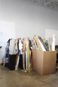 lot 131 image: HUGE LOT OF FABRIC ROLLS LEATHER SUEDE AND CLOTH ALL IN GOOD CONDITION (2 GARBAGE CANS NOT INCLUDED) MUST TAKE ALL