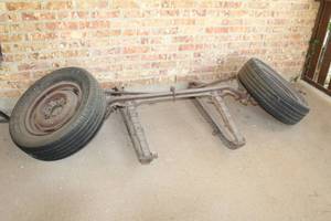 lot 66 image: 2 WHEEL AXLE WITH TIRE YARD DECOR