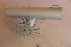 lot 67 image: METAL CANNON BALL WITH CAST IRON WHEELS YARD DECOR