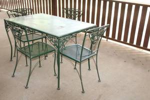 lot 186 image: VINTAGE 5 PC WROUGHT IRON PATIO TABLE AND CHAIRS WITH GLASS TOP