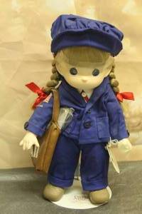 lot 34 image: 1999 PRECIOUS MOMENTS 12 DOLL COLLECTION MAIL CARRIER 4TH EDITION CAREER SERIES No. 1310 WITH STAND&nbsp
