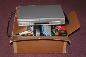 lot 174 image: MAGNAVOX DVDVCR PLAYER WITH DVDS AND VCR TAPES&nbsp