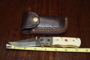 lot 97 image: DAMACAS STEEL FOLDING KNIFE WITH CUSTOM HAND CARVED HANDLE