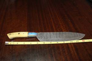 lot 111 image: DAMASCAS STEEL CHEFS BUTCHERS KNIFE WITH CUSTOM HAND CARVED HANDLE