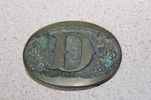 lot 180 image: VINTAGE AWARD DESIGN MEDALS ADM LETTER D SOLID BRASS FLORAL BELT BUCKLE