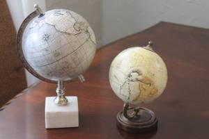 lot 69 image: TOTAL OF 2 DESKTOP  WORLD GLOBES - WHITE  MARBLE BASE 12 MODERN GLOBE MADE IN INDIA &  VINTAGE HIGGINS AMERICAN INDIA INK  WOOD BASE WORLD GLOBE 9 H