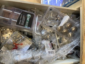 lot 295 image: DRAW FULL OF DRAWER PULLS DOOR STOPPERS HINGES AND MORE
