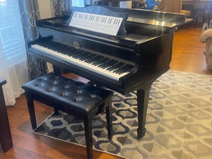lot 4 image: BALDWIN GRAND PIANO ON WHEELS  WITH LEATHER TOP BENCHBUYER MUST BRING HELP AND PICK UP EARLY ENOUGH TO HAVE PIANO OUT OF HOME BEFOR 6PM