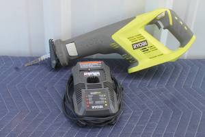 lot 202 image: RYOBI SAW P515 WITH RYOBI CHARGER P118