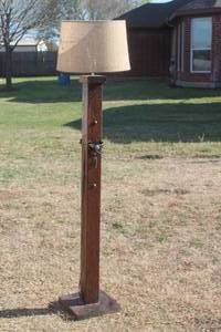 lot 78 image: WOOD FLOOR STANDING  LAMP WITH VINTAGE STYLE COWBOY SPURS  &  LAMP SHADE 5FT. H