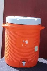 lot 107 image: 10 GALLON ORANGE WATER COOLER WITH HANDLES & CUP DISPENSER