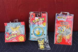 lot 136 image: TOTAL OF 4 VINTAGE POKEMON PIKACHU COLLECTIBLE   LOT  SEE PICS UNOPENED
