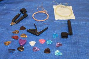 lot 231 image: LOT OF GUITAR ACCESSORY LOT - STRING WINDERS , REPLACEMENT STRINGS, CAPO, PICKS  SEE PICS&nbsp