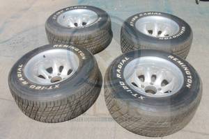 lot 27 image: TOTAL OF 4 ALUMINUM WHEEL RIMS&nbsp 118 15X10&nbsp WITH REMINGTON XT-120 RADIAL TIRES  SEE PICS&nbsp