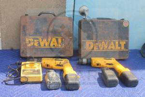 lot 135 image: TOTAL OF 2 DEWALT DW945 CORDLESS VERSA VSR CLUTCH DRILL WITH 2-12.0 VOLT&nbsp BATTERIES  DEWALT STANDING CHARGER&nbsp DW9104 WITH 2- DEWALT METAL STORAGE CASES&nbsp