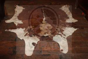 lot 64 image: LARGE COWHIDE BROWNWHITE RUG, 59L X77W&nbsp