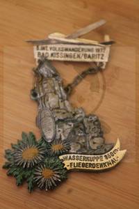 lot 181 image: 1977&nbsp 5TH INTERNATIONAL VOLKSEANDERUNG&nbsp HIKE&nbsp IN&nbsp GERMANY&nbsp BAD KISSINGENGARITZ ON THE WASSERKUPPE FEATURING AN IMAGE OF THE&nbsp AVIATOR MONUMENT 950 M-FLIEGERDENKMAL MEDAL PIN&nbsp