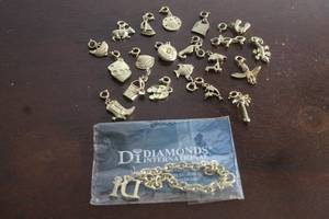 lot 190 image: DI DIAMOND INTERNATIONAL GOLD TONE CHARM BRACELET WITH 23 ASSORTED GOLD TONE CHARMS  SEE PICS&nbsp
