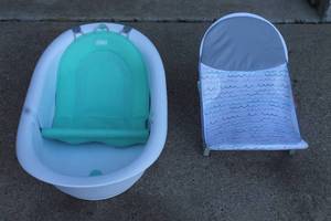 lot 170 image: FRIDA BABY 4 -IN -1 GROW WITH ME BATH TUB 10100101 &amp THE FIRST YEARS SURE COMFORT FOLDING BABY BATHER LOUNGER&nbsp