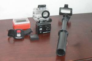 lot 214 image: DRAGON TOUCH 4K ULTRA HD VISION 3&nbsp ACTION CAMERA , BATTERY , CEAR WATERPROOF HOUSING , WIRELESS WRIST REMOTE CONTROL ,FLOATY BACKDOOR AND MINI TRIPOD  SEE PICS&nbsp