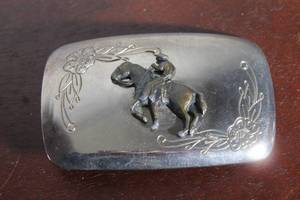 lot 144 image: VINTAGE&nbsp STYLE WESTERN SILVER TONE BELT BUCKLE FEATURING A THREE DIMENSIONAL COWBOY ON A HORSE MOTIF&nbsp