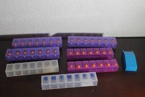 lot 107 image: TOTAL OF 7&nbsp CVS WALGREENS WEEKLY PILL ORGANIZERS AND PILL CUTTER&nbsp