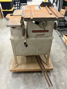 lot 46 image: VINTAGE 1950S DELTA HOMECRAFT AW-7088 SAW AND AW-5435 PLANNER ORIGINAL CAST IRON BASE MONTED TO WOOD BASE WITH CASTERS.