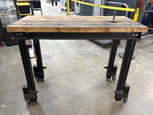 lot 49 image: APPERAS TO BE A HOMEMADE BUTCHER BLOCK TABLE WITH AIR COMPRESSOR LIFT ON CASTERS AND FEET.&nbsp