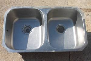 lot 5 image: Stainless steel double-basin undermount kitchen sink showing light surface wear and residue around the rim.