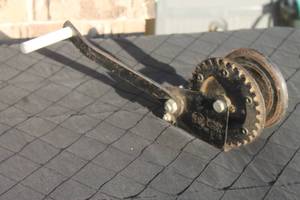 lot 22 image: Vintage Sears hand-crank boat trailer winch with black painted finish.