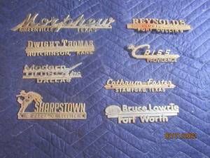 lot 73 image: VINTAGE METAL DEALERSHIP EMBLEM BADGES  LOT OF 8.