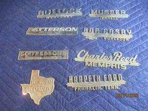 lot 74 image: VINTAGE METAL DEALERSHIP EMBLEM BADGES  LOT OF 8.