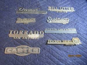 lot 83 image: VINTAGE METAL DEALERSHIP EMBLEM BADGES  LOT OF 8.