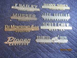 lot 86 image: VINTAGE METAL DEALERSHIP EMBLEM BADGES  LOT OF 8.