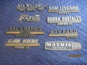 lot 203 image: VINTAGE PLASTIC DEALERSHIP EMBLEM BADGES LOT OF 8.