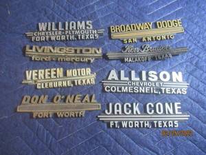 lot 201 image: VINTAGE PLASTIC DEALERSHIP EMBLEM BADGES LOT OF 8.