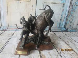 lot 92 image: SIGNED LISA PERRY &amp NUMBERED 10100&nbsp -THE FIRST BULL DOGGER - BILL&nbsp PICKETT SCULPTURE DEPICTING BILL PICKET WRESTLING A STEER TO THE GROUND&nbsp