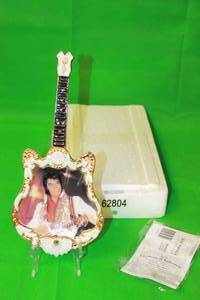 lot 52 image: ELVIS PRESLEY 1975,THE SPIRIT , FOURTH ISSUE IN ENTERTAINER OF THE CENTURY , GUITAR PLATE No A10730, WITH COA ,13