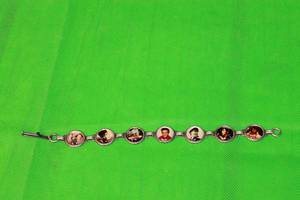 lot 73 image: ELVIS PRESLEY,SILVER LINK MEMORY LANE PHOTO BRACELET