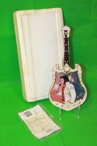 lot 109 image: ELVIS PRESLEY  THE EXCITEMENT  FOURTEENTH ISSUE IN ENTERTAINER OF THE CENTURY GUITAR PLATE No A1828 ,WITH COA, 13 H
