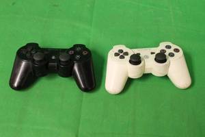 lot 236 image: TOTAL OF 2 SONY CECHZC2U WIRELESS DUAL SHOCK3 CONTROLLERS