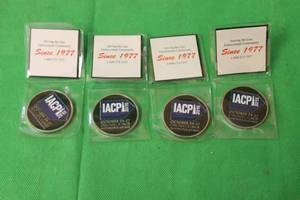 lot 20 image: 4 IACP 2015 RED THE UNIFORM TAILOR CHALLENGE COINS