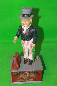 lot 185 image: VINTAGE UNCLE SAM MECHANICAL CAST IRON COIN BANK