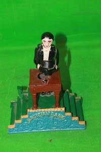 lot 186 image: VINTAGE MAGICIAN MECHANICAL CAST IRON COIN BANK