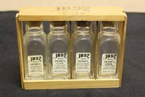 lot 210 image: TOTAL OF 4 VINTAGE 1852 HONEY ACRES 4 OZ BOTTLES WITH WOOD STORAGE&nbsp